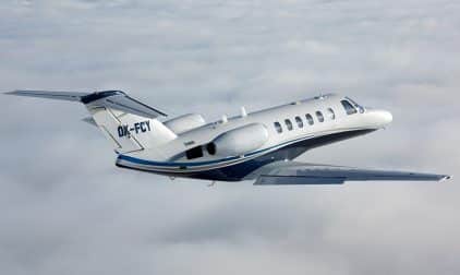 A Cessna Citation soars above the clouds