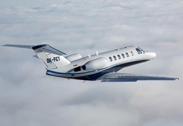 A Cessna Citation soars above the clouds