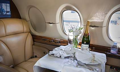 Luxury Private Jet Champagne and Meal Table Set Up | Stratos Jet Charters, Inc.