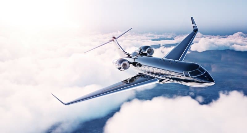 A private jet soaring above the clouds.