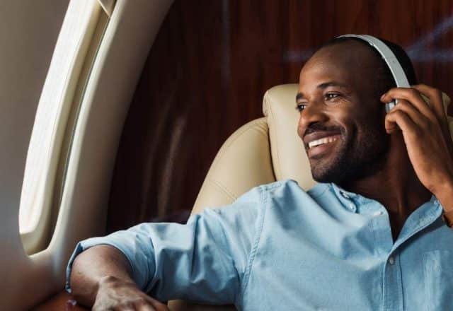 man wearing headphone enjoying private jet charter