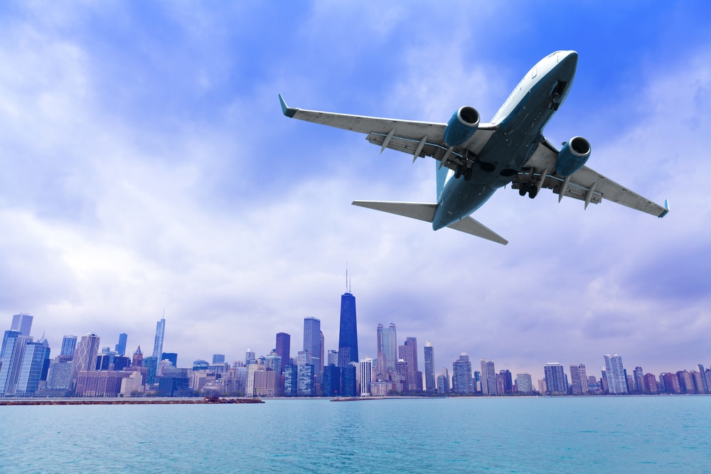 A private jet taking off against a backdrop of downtown Chicago.