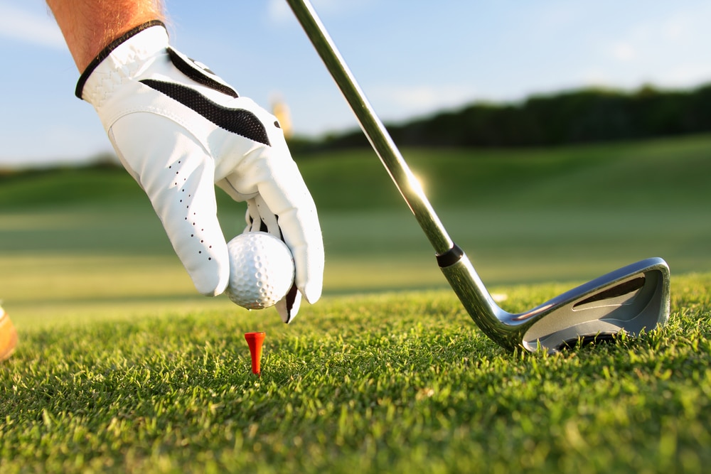 A golfer tees up, ready to hit the links in San Diego, CA.