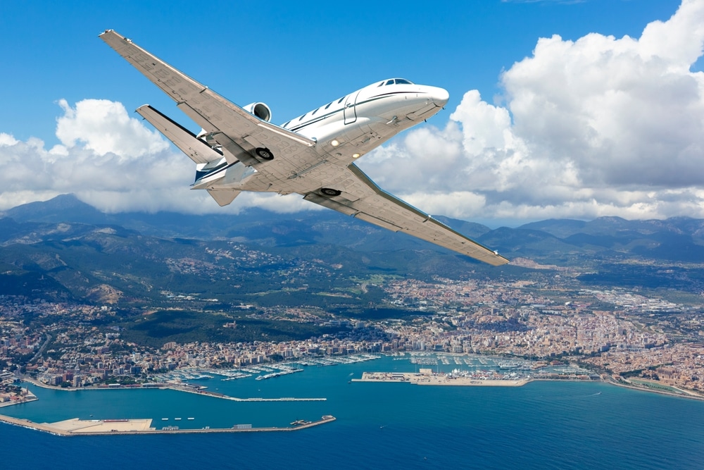 A passenger jet flying over the coast of Spain