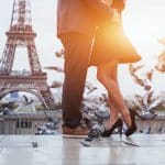 A couple celebrates their love in front of the Eiffel Tower.