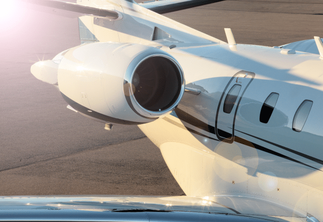 A fast private jet sits on the tarmac.