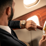 A private flier checks their watch while in the sky. Here's what you need to know about how long jet lag lasts.